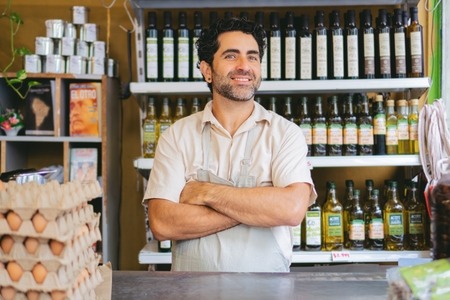 Latin,Man,Greengrocer,In,An,Organic,Grocery,Shop,Behind,The